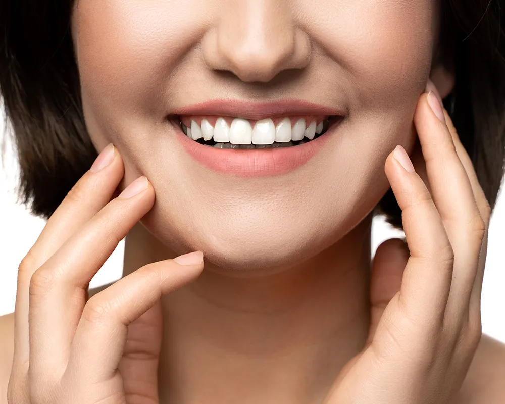 A woman with a radiant smile, showcasing the results of Cosmetic Dentistry in St. Clair