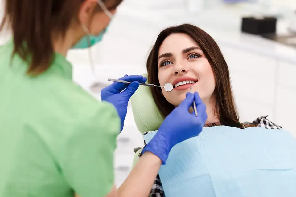 beautiful-young-woman-doing-tooth-examination Why Recognizing the Signs You Need a Dental Exam Matters