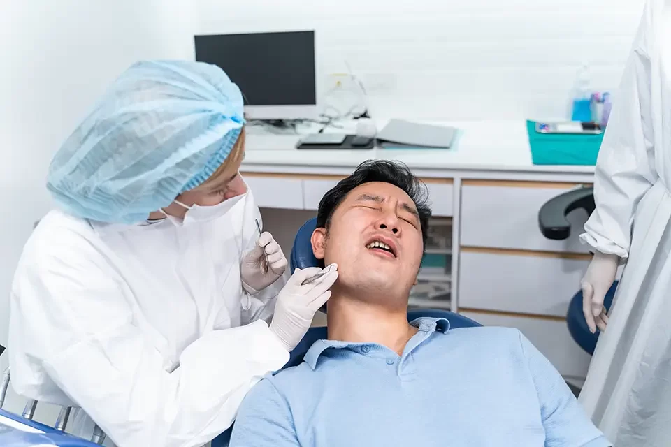 caucasian-dentist-examine-tooth Signs You Need a Dental Cleaning: The Importance of Dental Cleanings