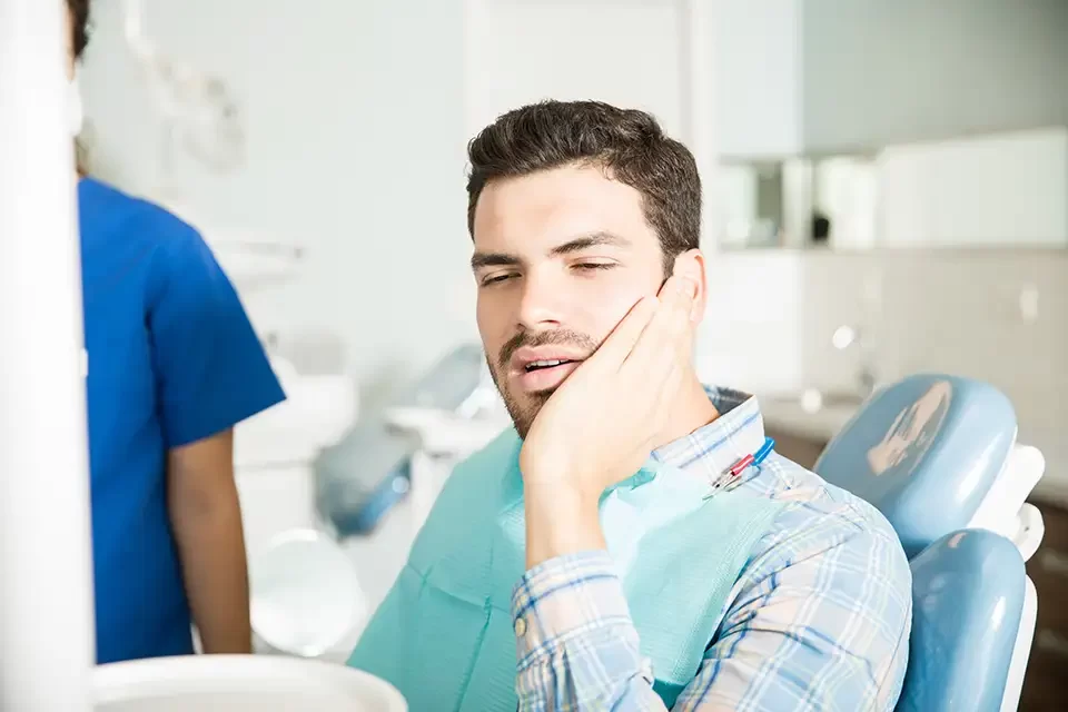 man-suffering-from-toothache-in-dental-clinic Why Impacted Wisdom Teeth Need Attention